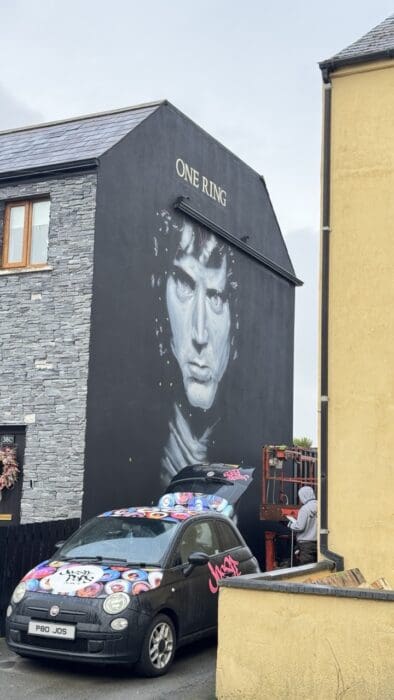 mural with jossie pops car parked in front